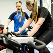 Two female students in the college gym .