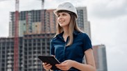 Female architecture standing in front of construction sites