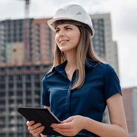 Female architecture standing in front of construction sites