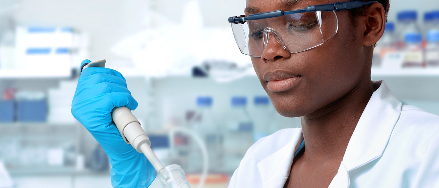 female medical scientist using a syringe and test tube
