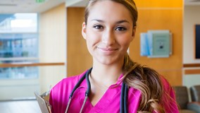 Hospital worker wearing pink scrubs and a stethoscope
