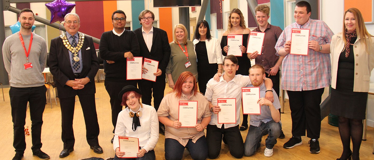 Prince's Trust award winners standing in a line showing their certificates on complete of their course with the Mayor