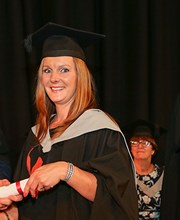 Higher Education student Phillippa Hines being handed certificate at graduation