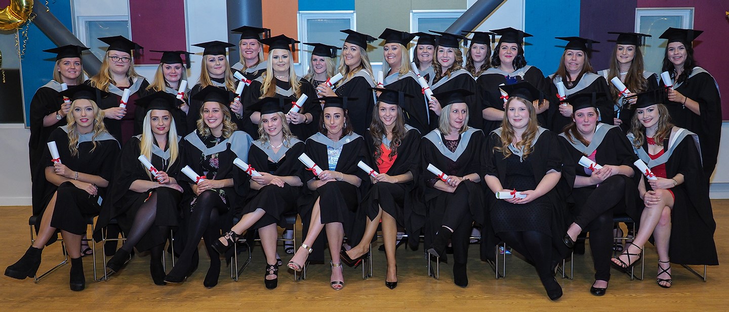 Higher Education students photographed in two lines at graduation after graduating