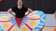 performing arts student rehearsing for upcoming show with butterfly wings as a prop
