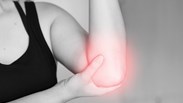 black and white photo with red around elbow indicated pain