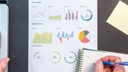 A professional worker analysing data with pie charts and graphs