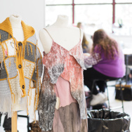 Students showcase creatively designed tops made from selected materials.