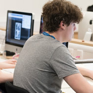 A male and female student working on their computer on visual Apprenticeship course.