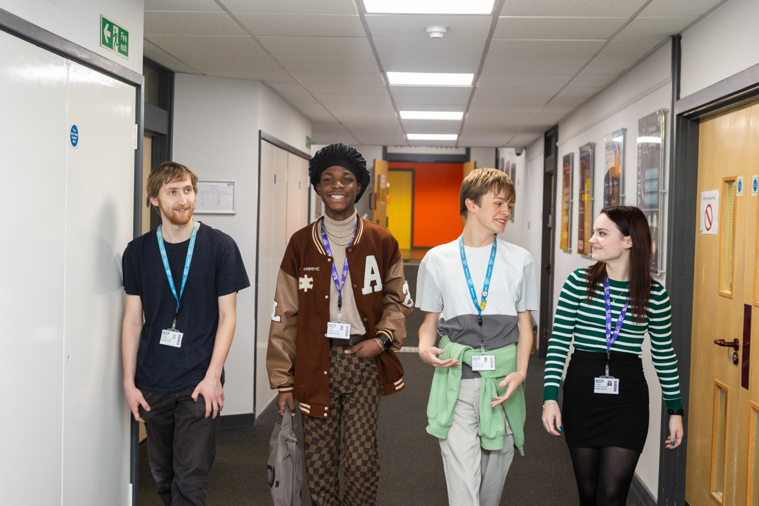 Students walking down a corridor.