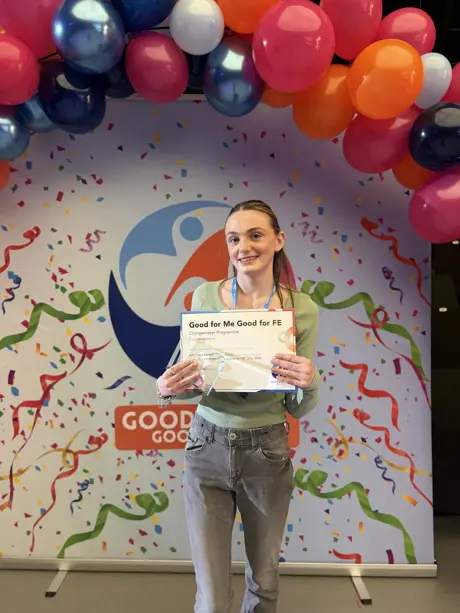 A girl holding up her award in the Seevic Theatre.